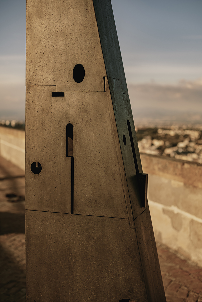 totemic sculptures compose volcanic stone landscape for site-specific installation in naples