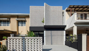 porous white brickwork facade enfolds renovated 1980s terrace house