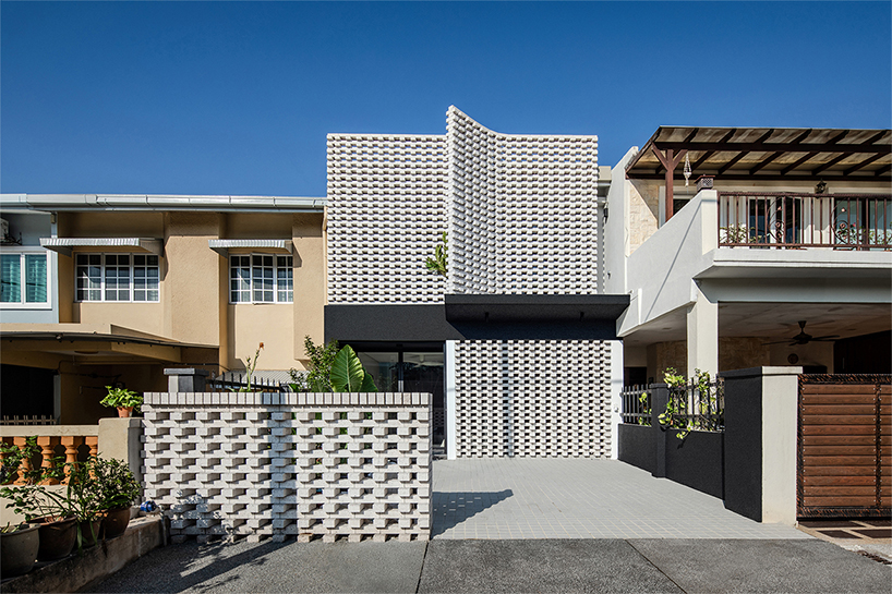 porous white brickwork facade enfolds renovated 1980s terrace house in kuala lumpur