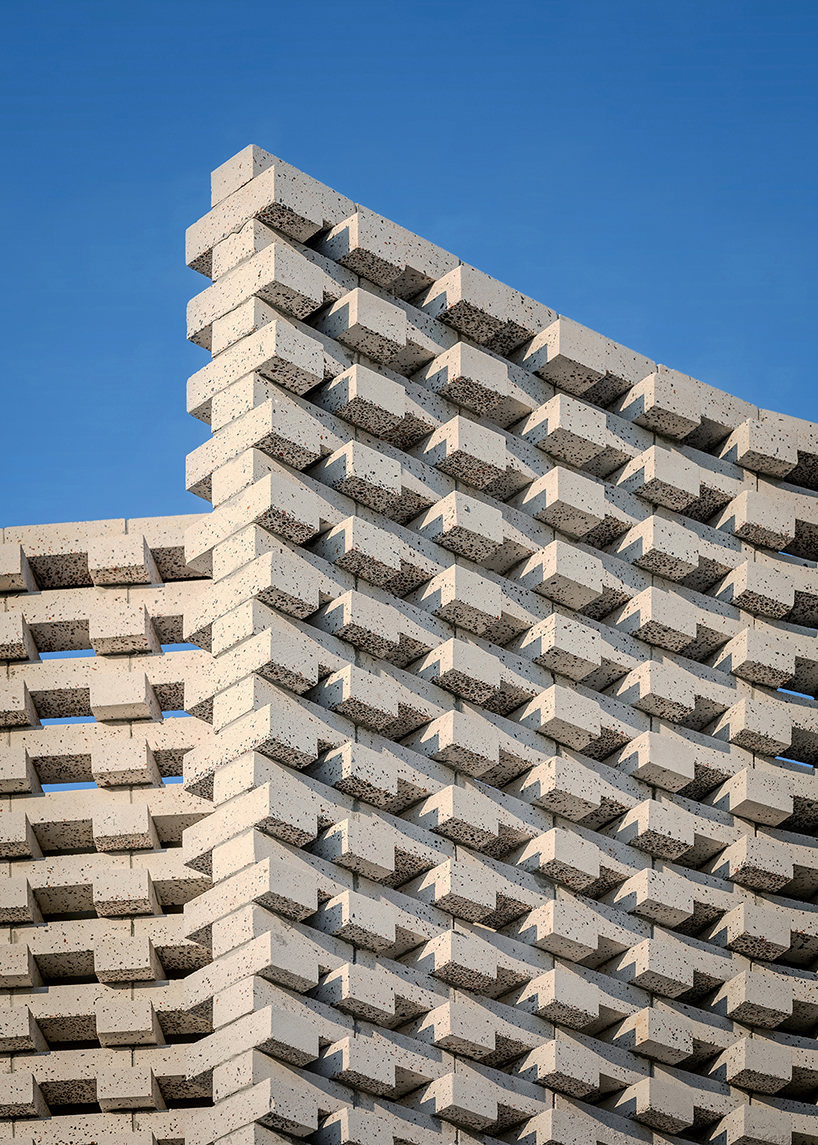 porous white brickwork facade enfolds renovated 1980s terrace house in kuala lumpur