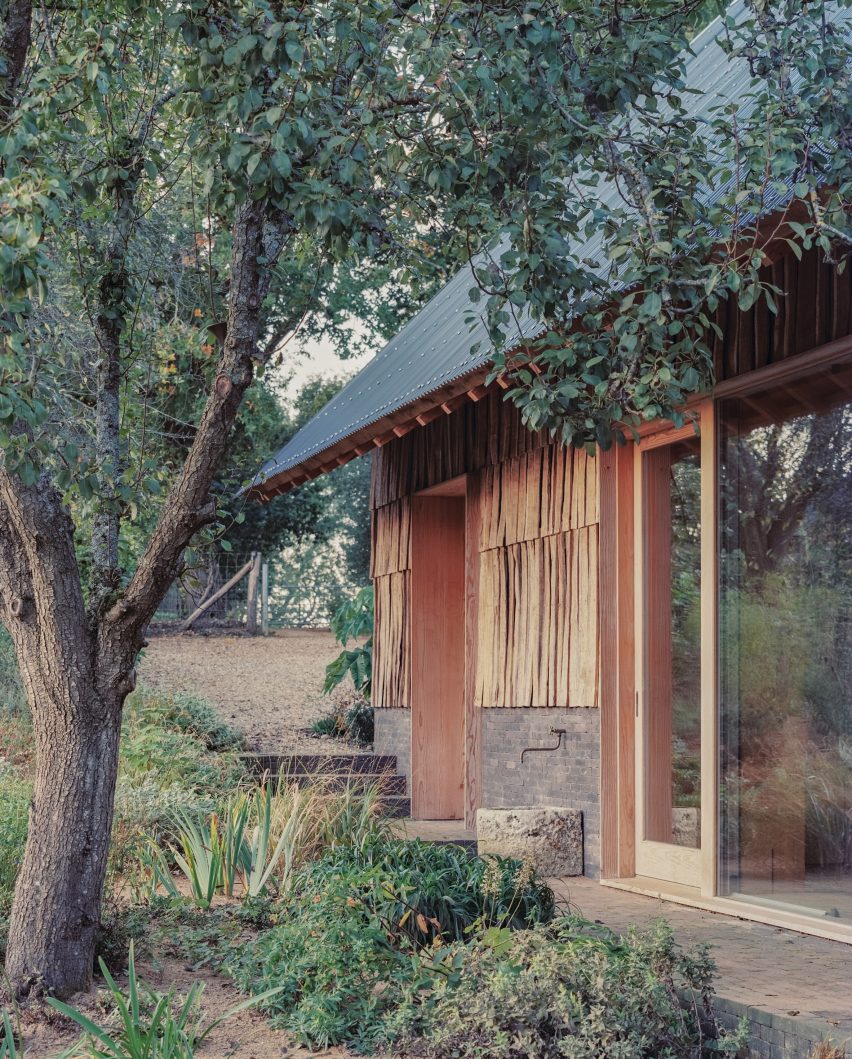 Shingle-clad exterior of education centre by Okra