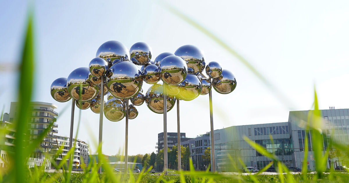 mirrored steel bubbles shape kinetic sculpture by vincent leroy in normandy