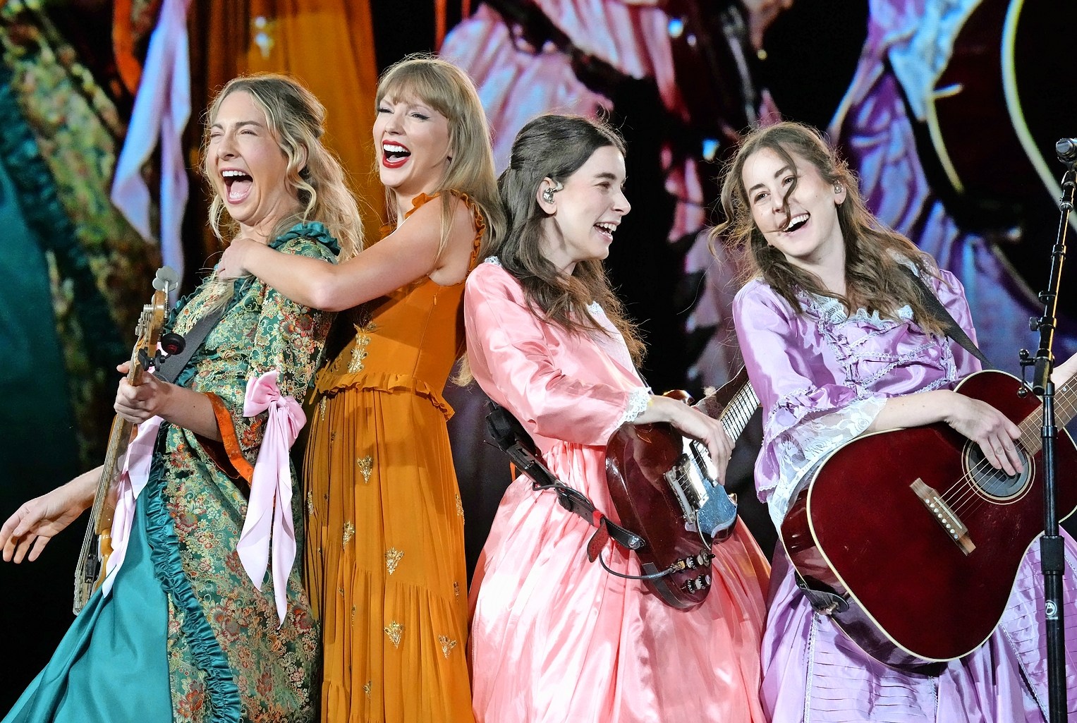 Este Haim, Taylor Swift, Danielle Haim, and Alana Haim perform onstage during Taylor Swift | The Eras Tour.
