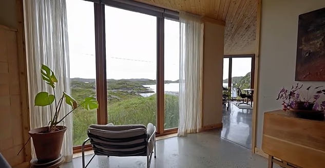 Interior of Caochan na Creige, House of the Year 2025, with large windows overlooking the island of Harris.