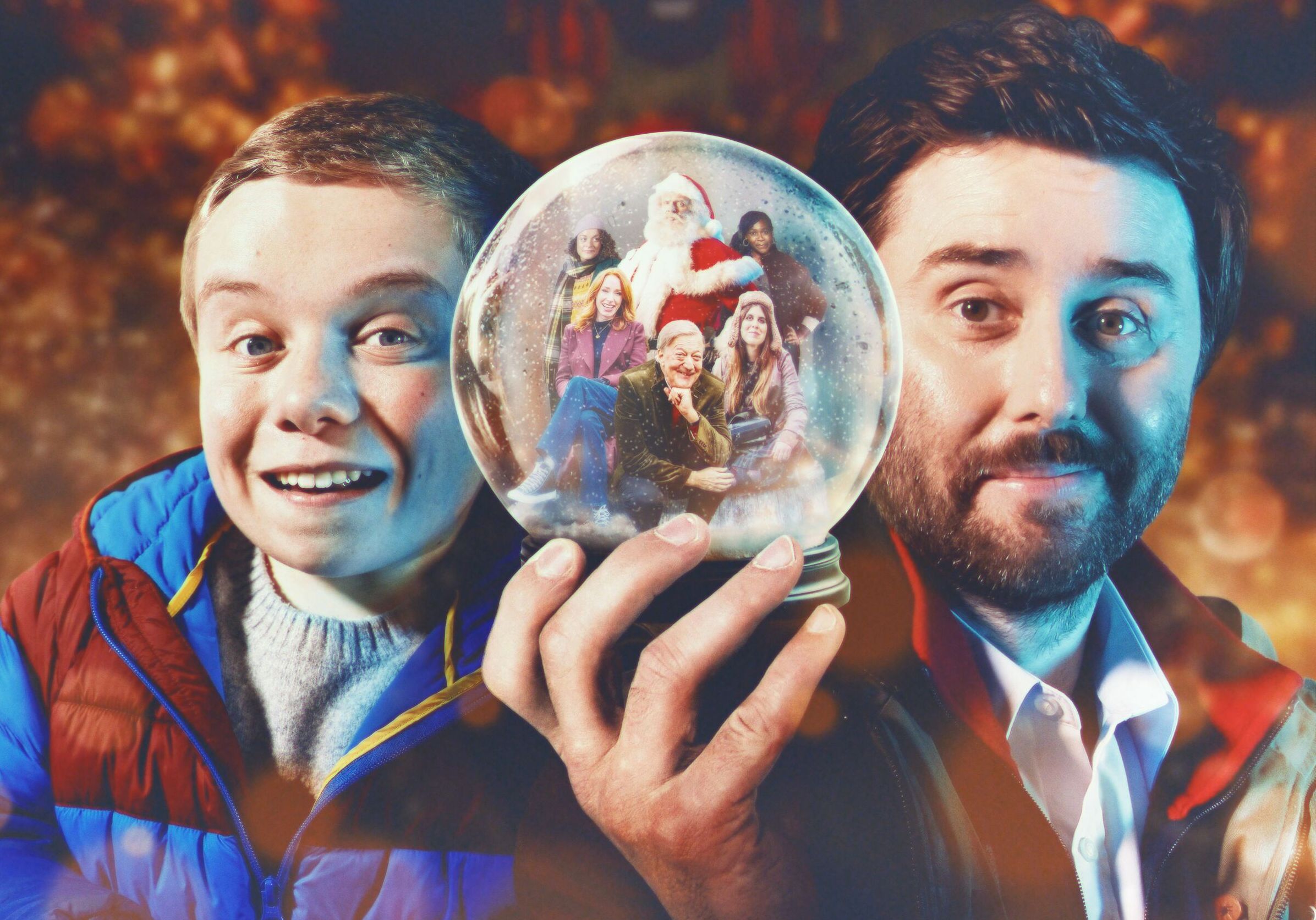Lenny Rush and an adult holding a snow globe with Santa, Stephen Fry, and others inside.