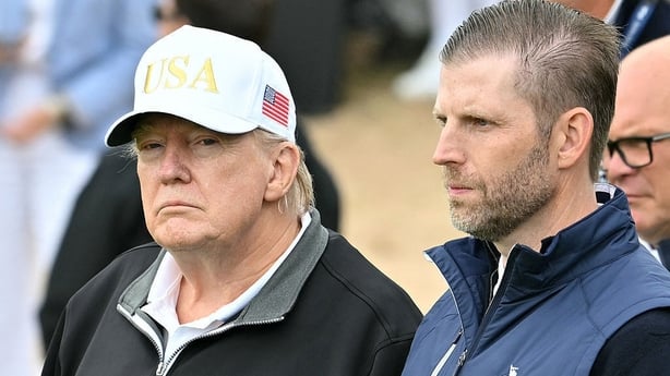US President Donald Trump (L) stands with his son Eric Trump