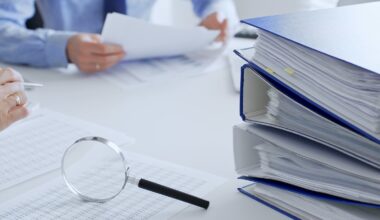 Accountants analyze financial reports in an office, flanked by a magnifying glass and documents.