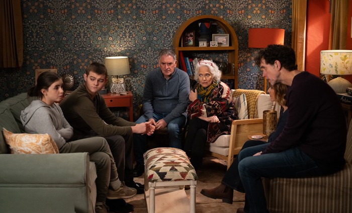 Dylan, Bob, Mary, Rhona and Marlon stare with worried expressions at April in a scene from Emmerdale
