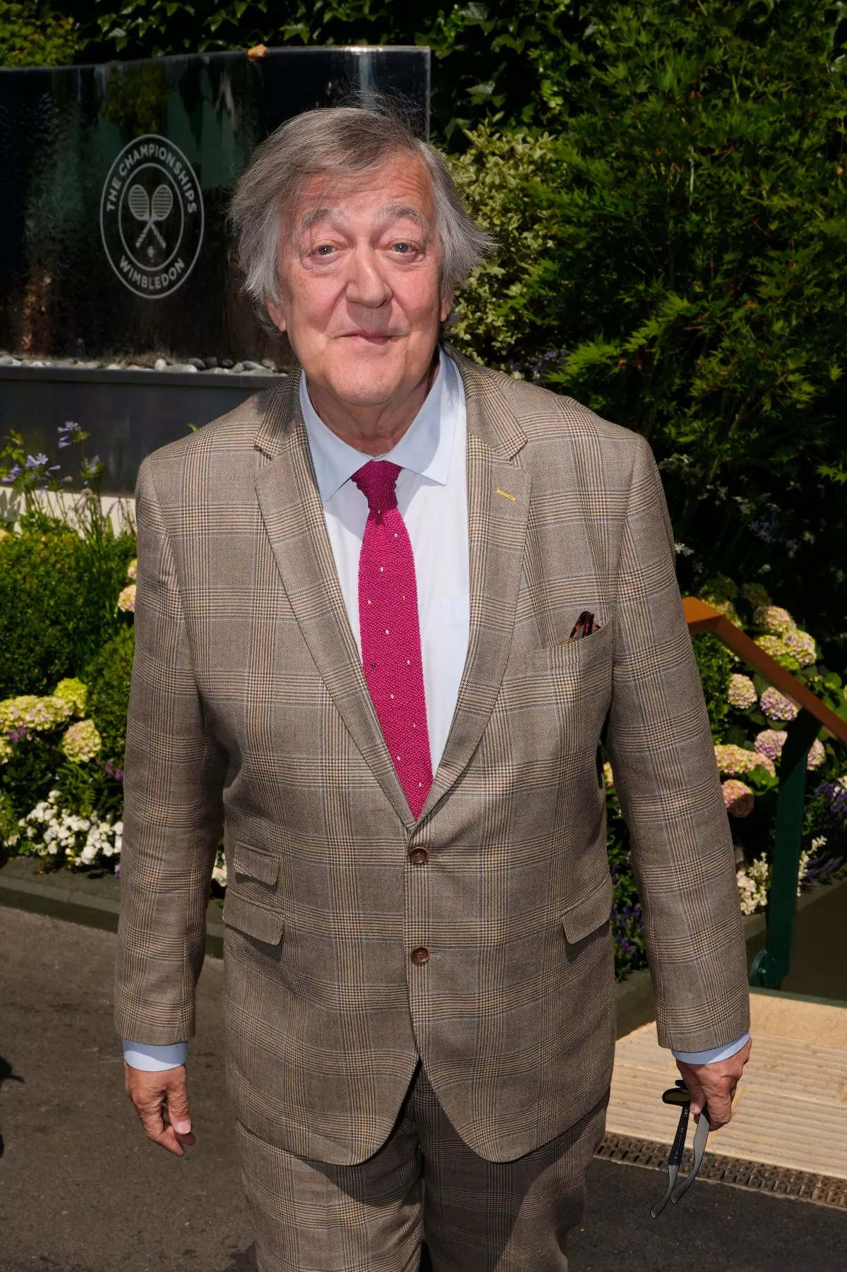 Sir Stephen Fry arrives on day eleven of the 2025 Wimbledon Championships at the All England Lawn Tennis and Croquet Club, London. Picture date: Thursday July 10, 2025. 