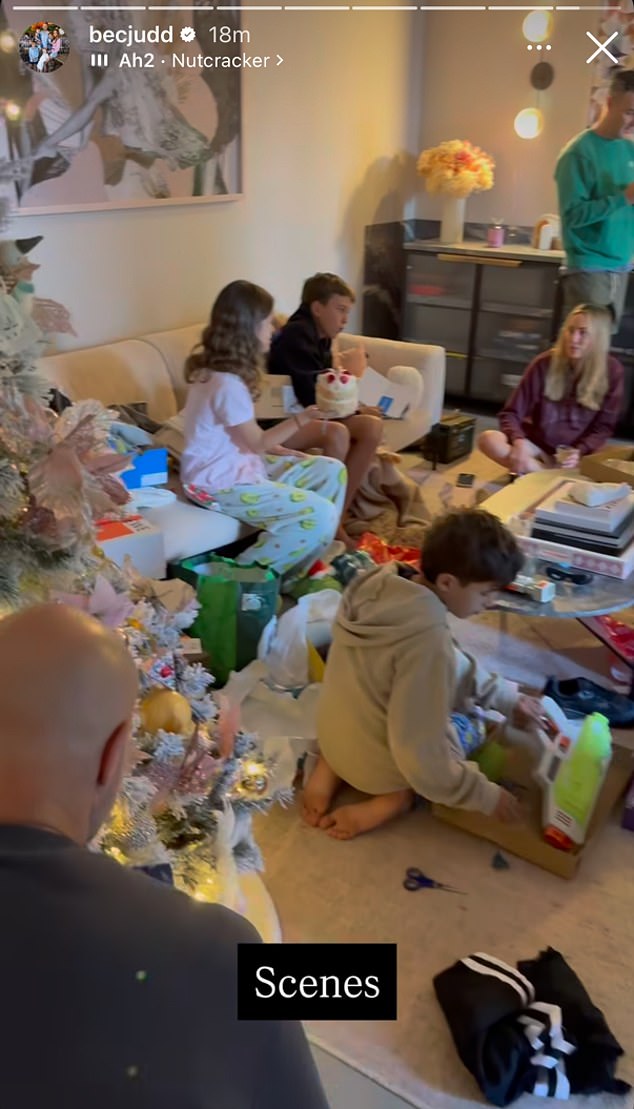 In the bustling scenes, the Judd living room was filled with open gift boxes, scattered wrapping paper and festive decorations, with the family gathered around a large, beautifully decorated Christmas tree