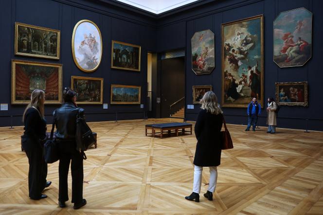 People look at paintings at the renovated gallery Salle Piazzetta in the Denon wing (Aile Denon) during a press preview at the Louvre Museum in Paris, France, December 2, 2025.