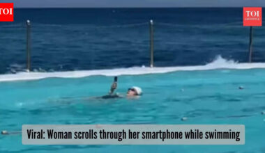 Peak addiction or beach boss move? Woman scrolls through phone while swimming, video goes viral |