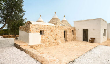 stone-domed trulli fuse with contemporary residence by studio8 in italy