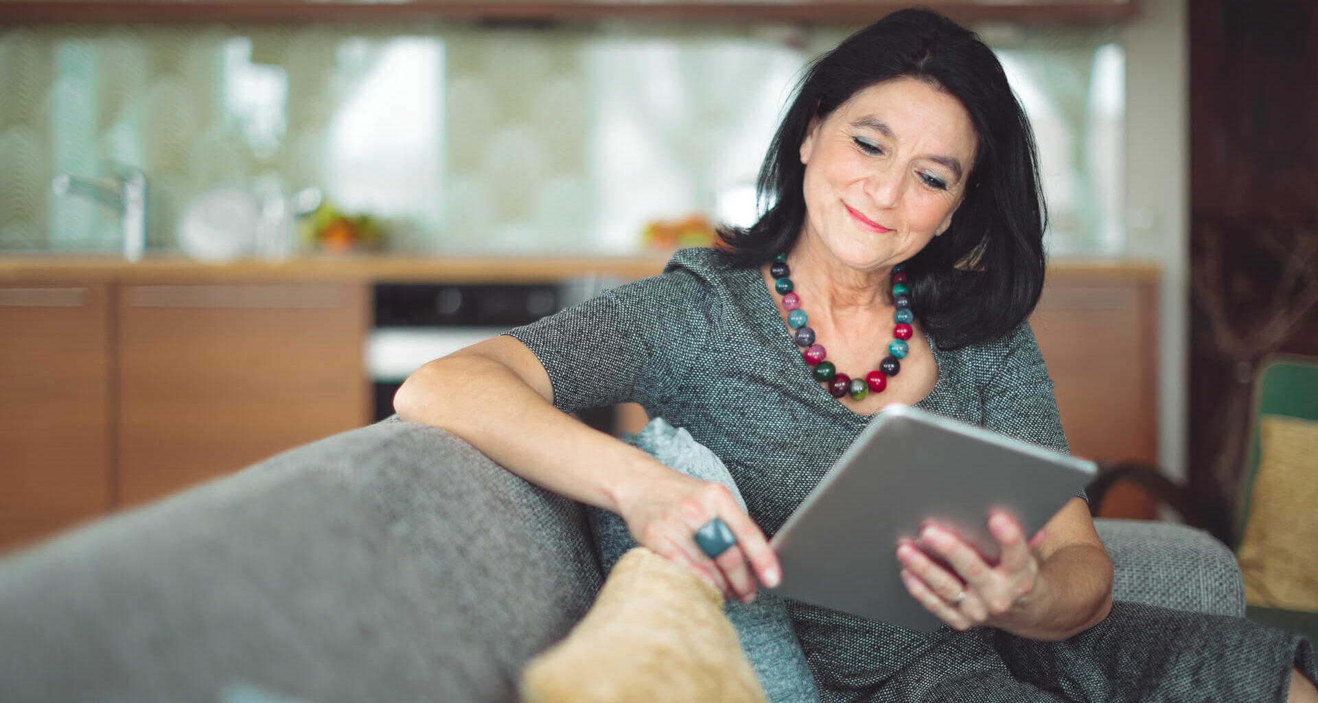 middle aged woman proof reading on tablet