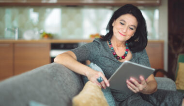 middle aged woman proof reading on tablet