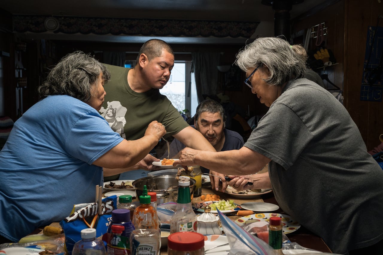 People around a table of food.