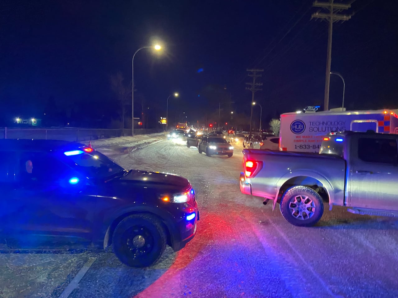 Cops redirect traffic away from localized flooding.