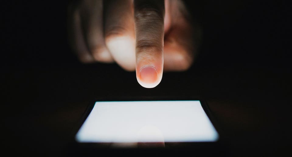 Man using phone in dark