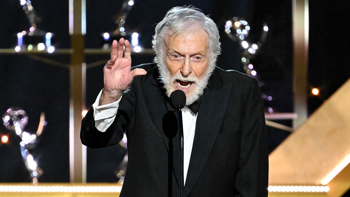 Dick Van Dyke speaking on stage in a tux.