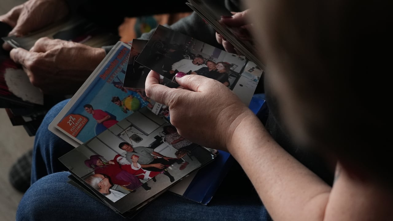 A woman holds stacks of printed photos