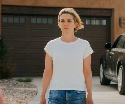 Rhea Seehorn standing outside her house in Pluribus Episode 7