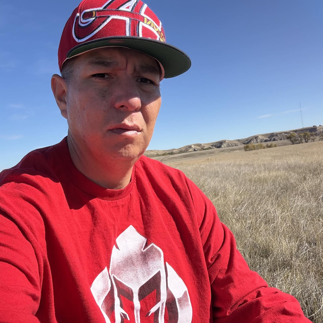 Alvin First Rider takes selfie in grassy field 