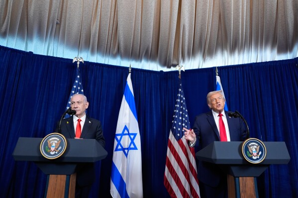 President Donald Trump speaks as Israel's Prime Minister Benjamin Netanyahu listens during a news conference at Mar-a-Lago, Monday, Dec. 29, 2025, in Palm Beach, Fla. (AP Photo/Alex Brandon)