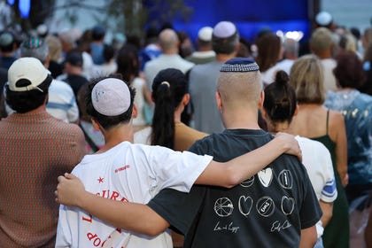 Mourners comforting each other at a memorial held last week for the victims of the Bondi massacre.