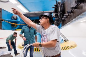 Freddie Martinez figures out electrical connections for testing of the VIPER rover at the Superfuge at Sandia National Laboratories. (Photo by David Lienemann) Click on thumbnail for a high-resolution image. 