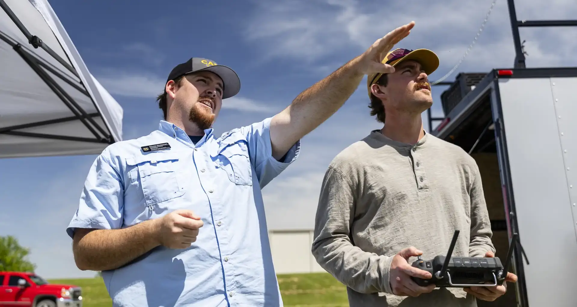 Rayne Faulconer, left, instructs Gage Singer as he flies a drone on an MU Extension field day in Montgomery City.