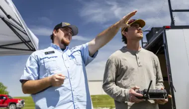 Rayne Faulconer, left, instructs Gage Singer as he flies a drone on an MU Extension field day in Montgomery City.