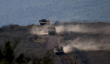 FILE PHOTO: Israeli military vehicles manoeuvre along the Israel-Lebanon border as seen from northern Israel