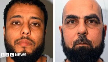 Police custody images of Walid Saadaoui and Amar Hussein, who are both wearing grey t-shirts. Walid Saadaoui has short dark hair and a dark beard. Hussein is bald and has a short dark beard.