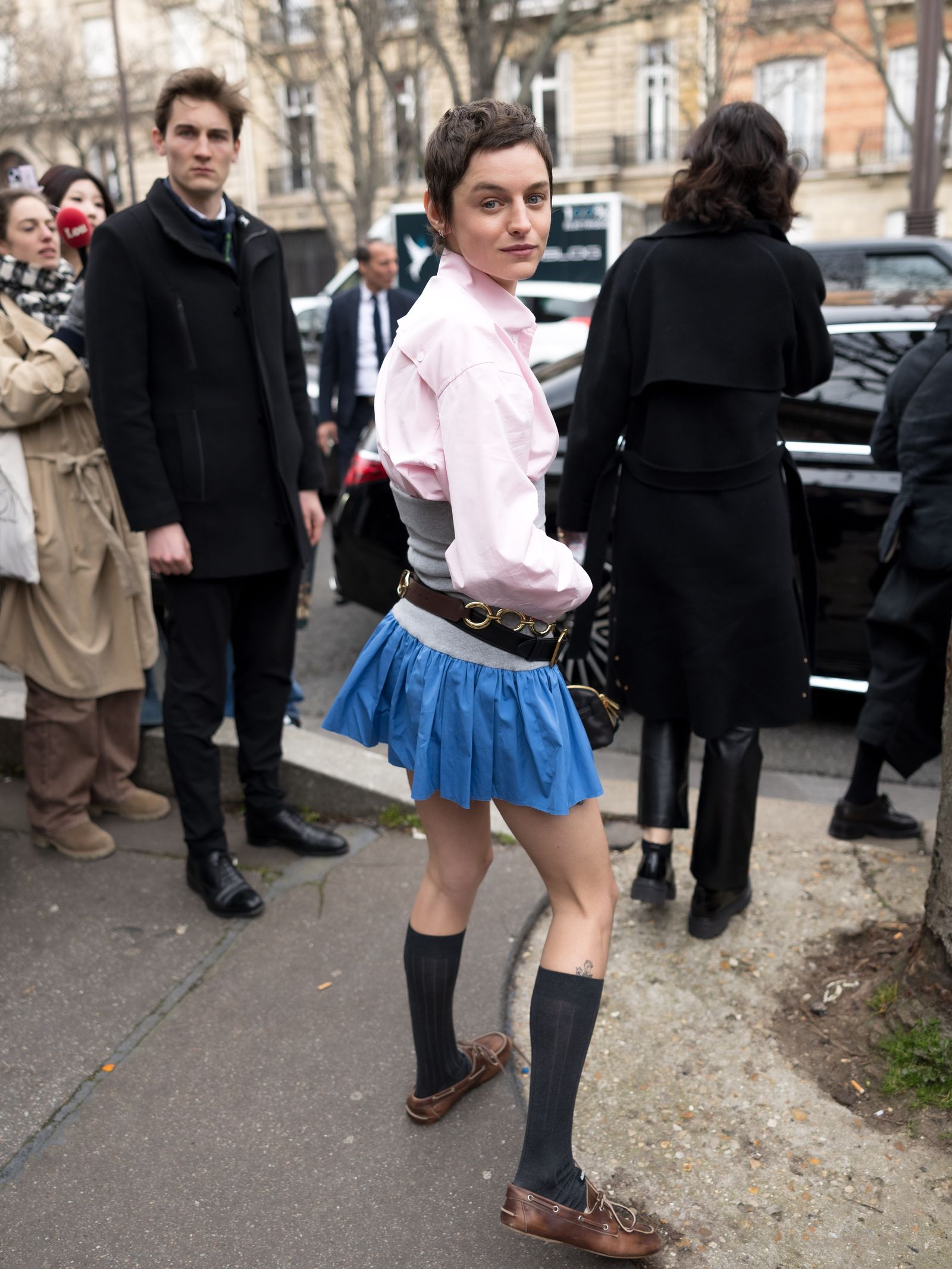 Image may contain Clothing Skirt Adult Person Coat Teen Footwear Shoe Accessories Formal Wear Tie and Bag