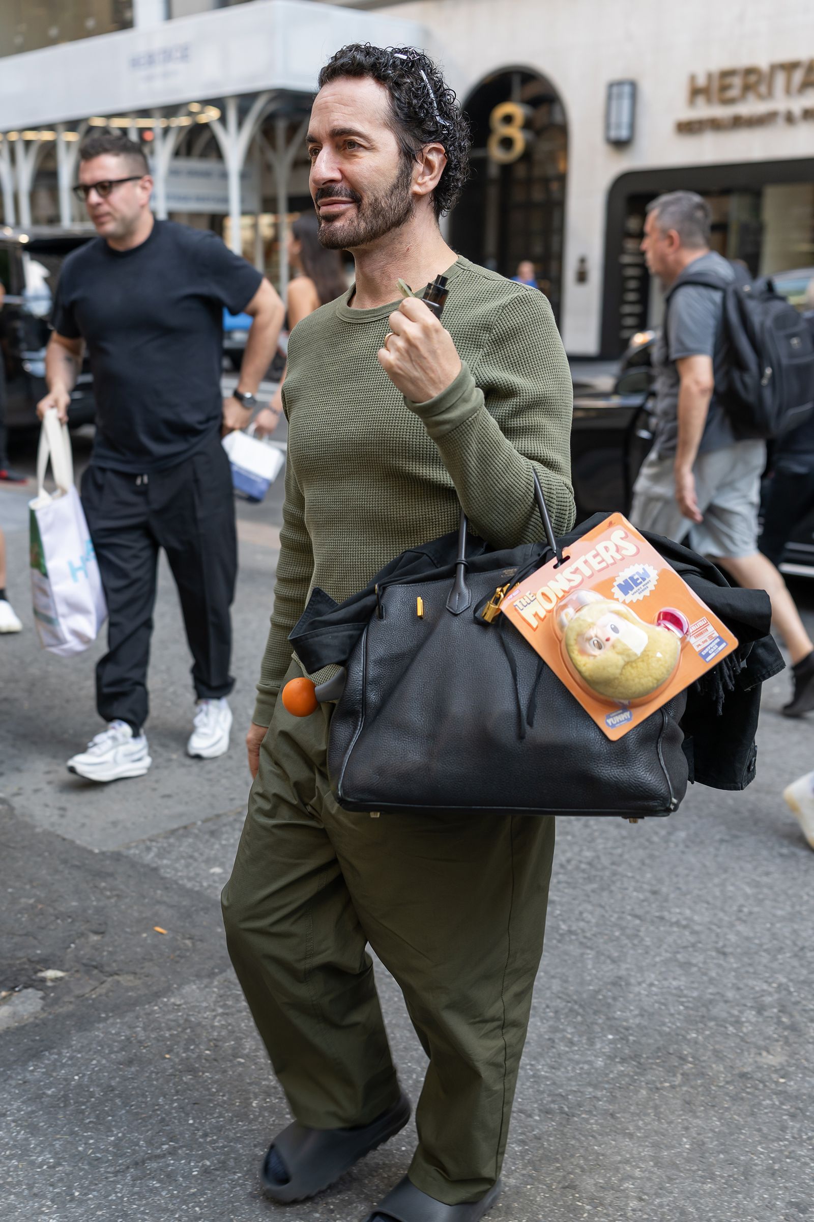 Image may contain Marc Jacobs Accessories Bag Handbag Pedestrian Person Face Head Adult Purse and Clothing