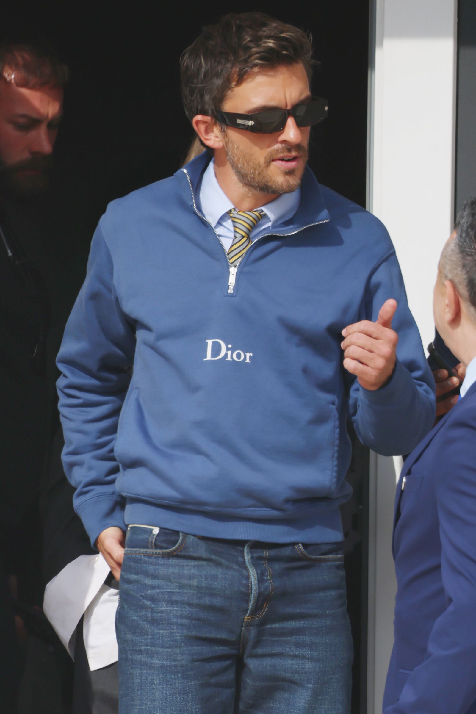 Image may contain Jonathan Bailey Clothing Shirt Coat Jacket Adult Person Jeans Pants Formal Wear and Suit