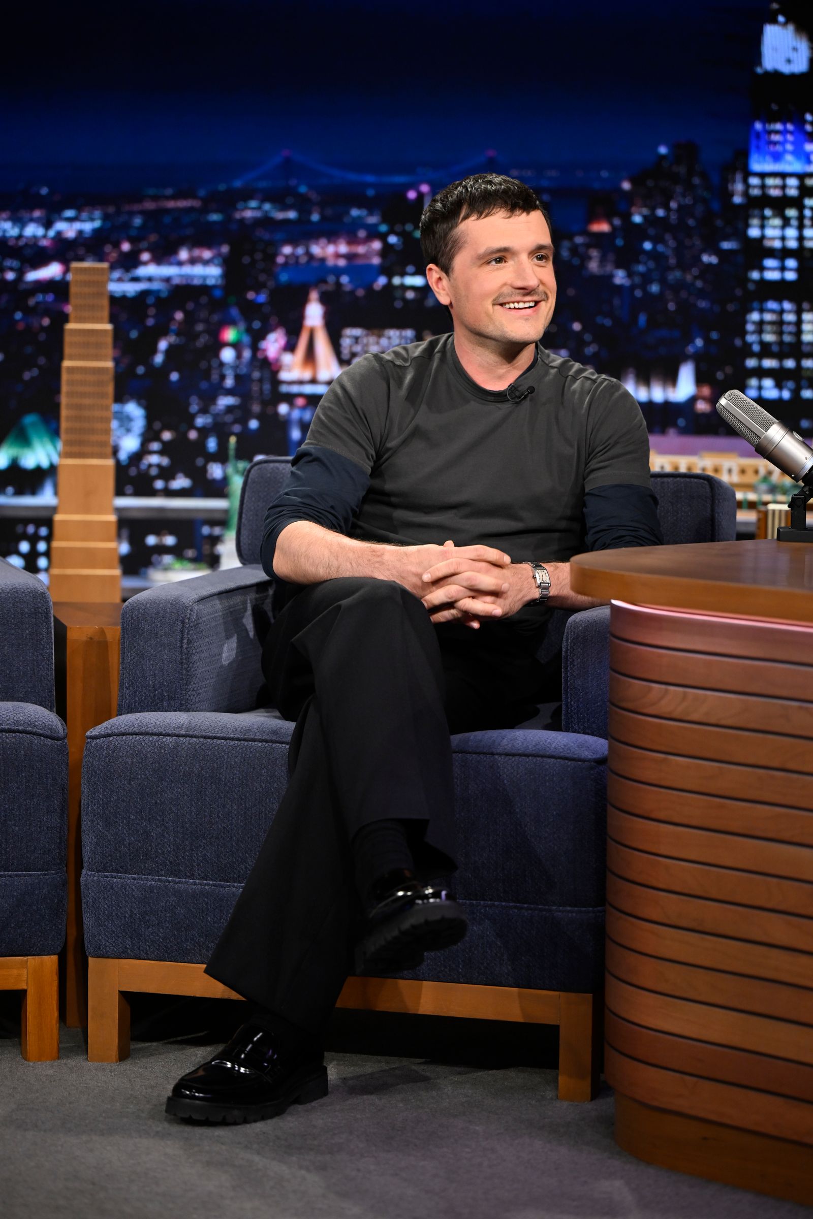 Image may contain Josh Hutcherson Adult Person Head Sitting Face Clothing Footwear Shoe Conversation and Interview