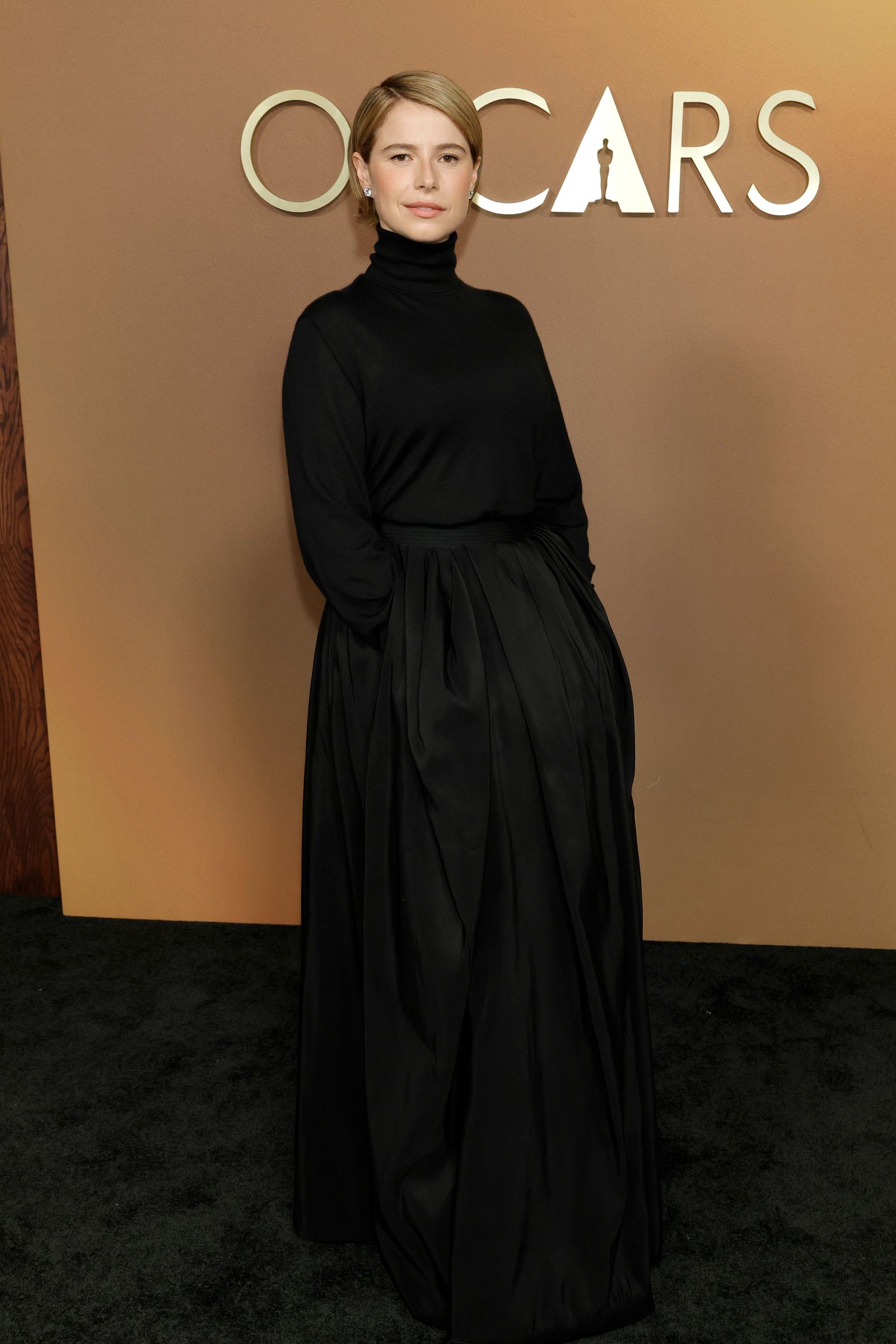 Image may contain Adult Person Fashion Clothing Dress Formal Wear Long Sleeve Sleeve Evening Dress Face and Head