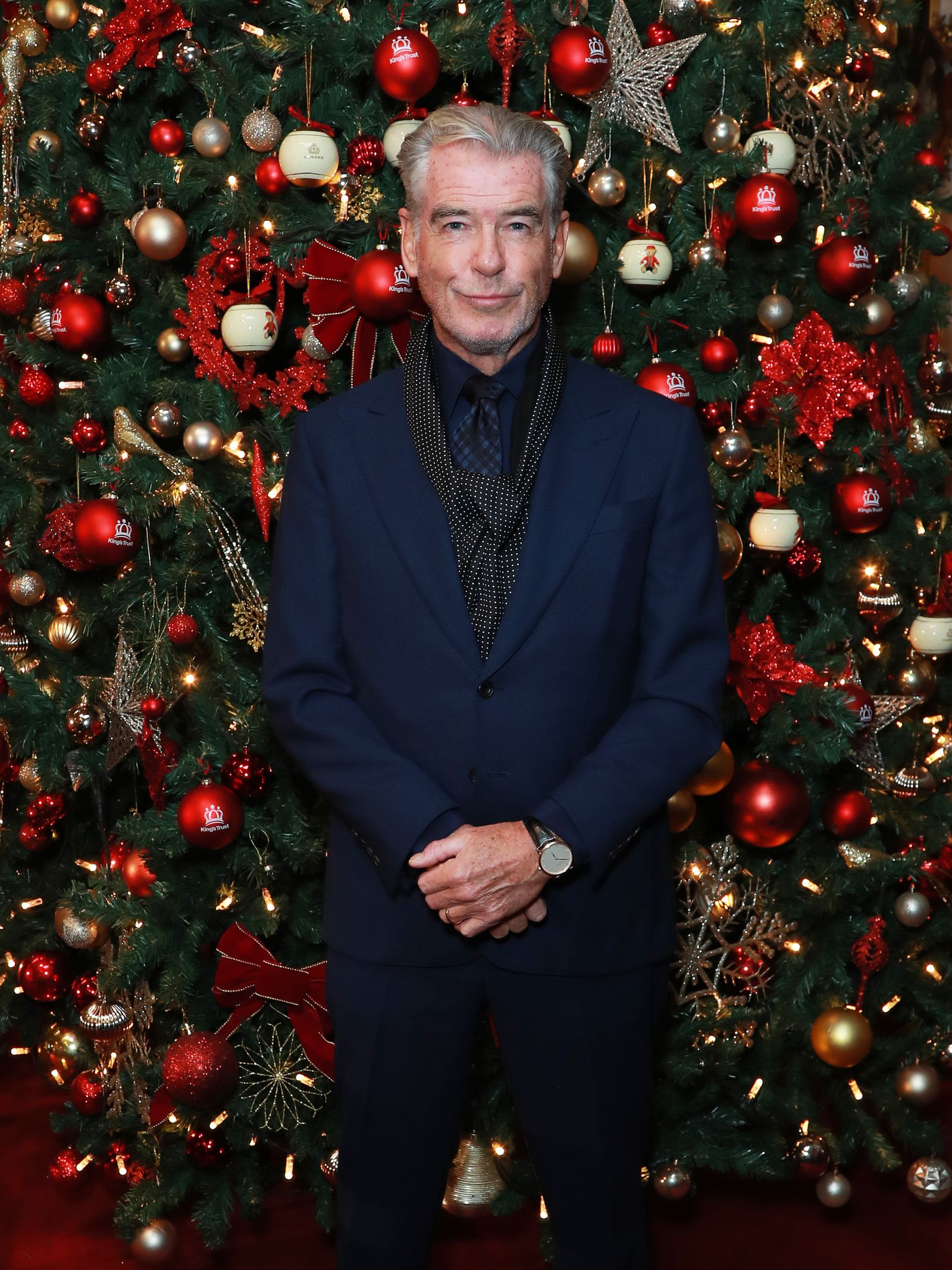Image may contain Pierce Brosnan Adult Person Clothing Coat Christmas Christmas Decorations Festival and Accessories