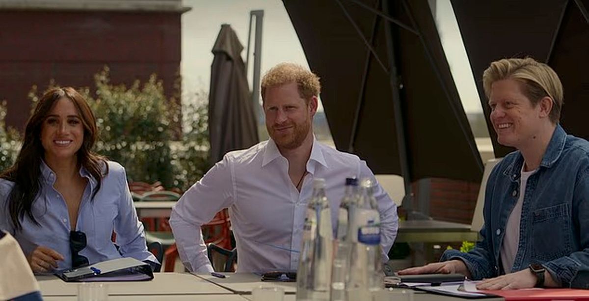 Meghan Markle, Prince Harrys, and James Holt sitting together at a table