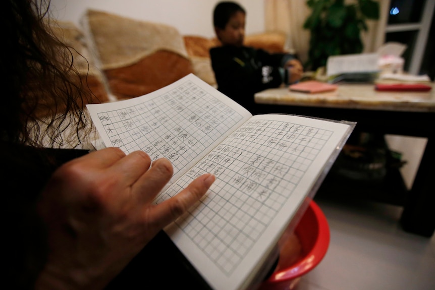 Chinese parents doing homework with their children.