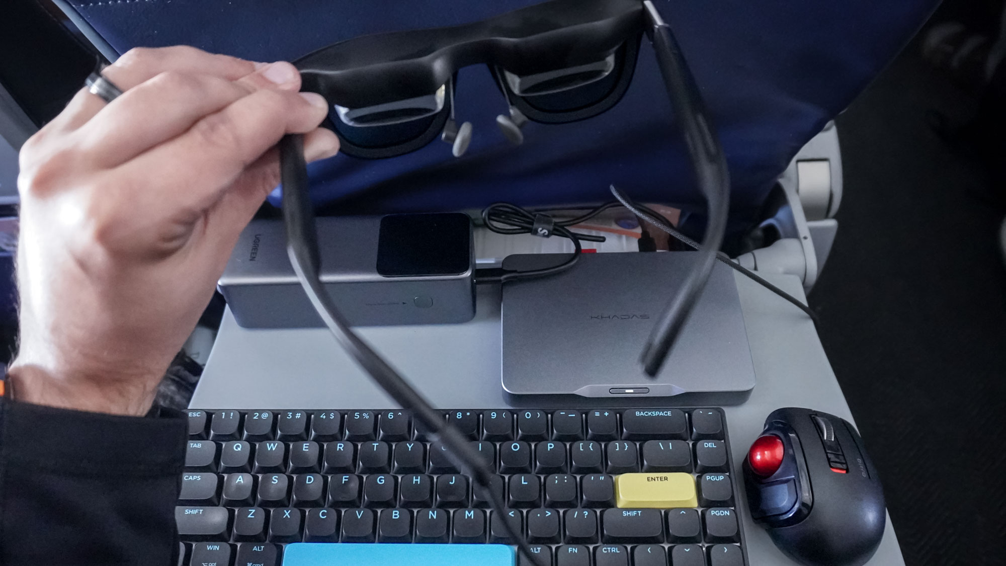 Using the Khadas Mind 2S and the Xreal One AR glasses on a tray table on an airplane
