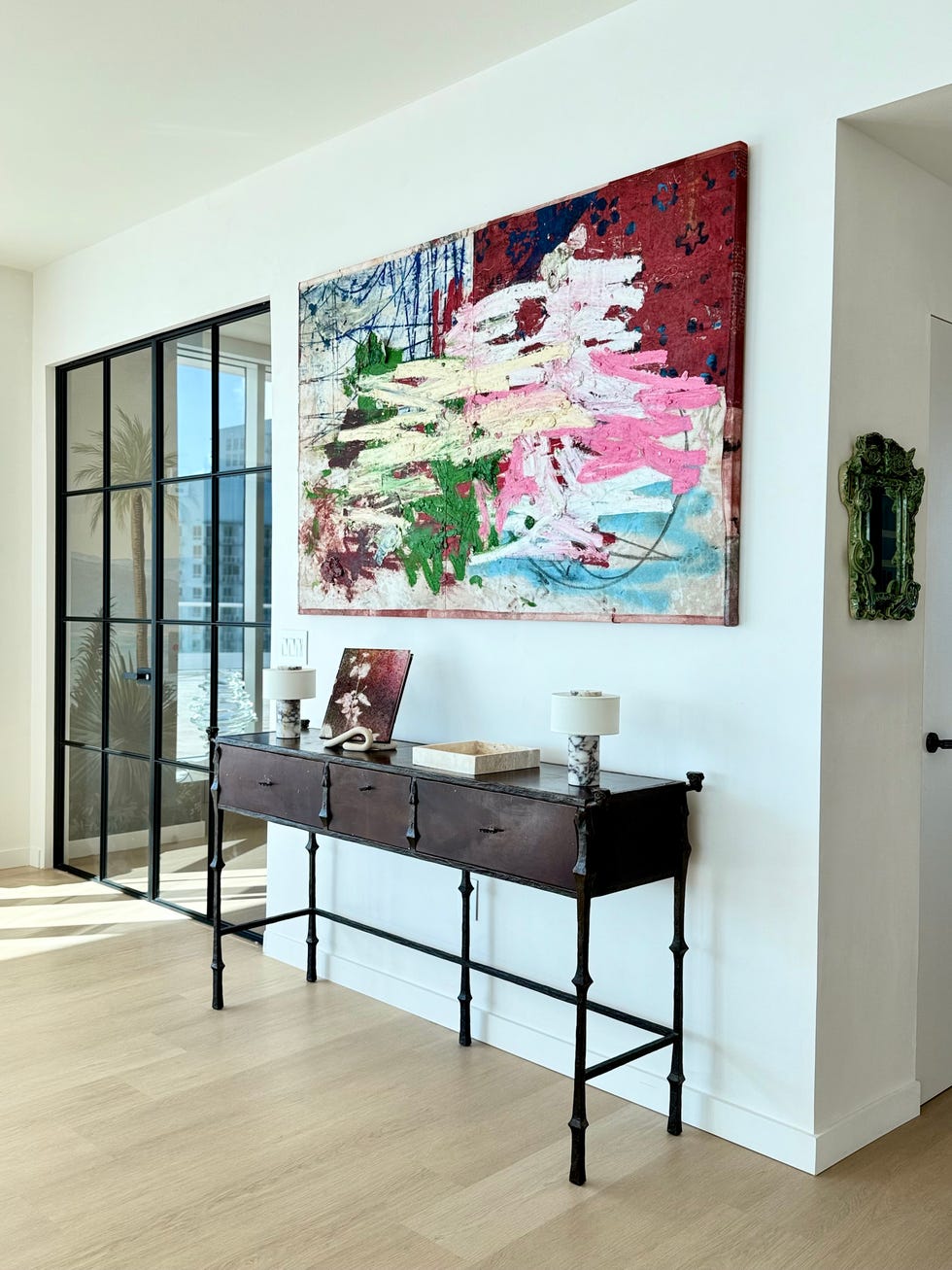 A stylish entryway featuring a console table and abstract art.