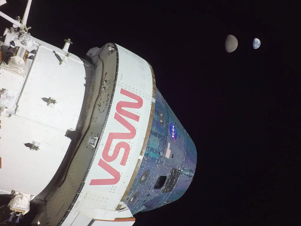 The Orion Capsule takes a "selfie" with the Moon and Earth. Credit - NASA