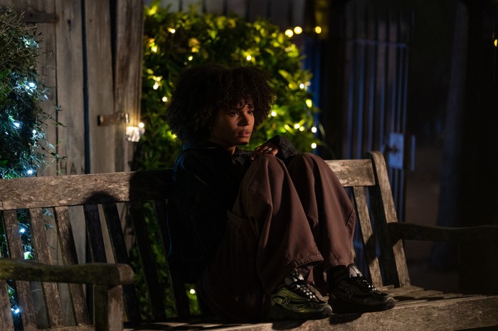 539201,TITLE:Eastenders Jasmine sits alone with her feet up on a park bench with a Christmas tree behind her in EastEnders