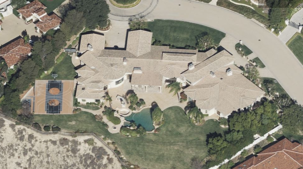 Residential property with a basketball court and landscaped yard