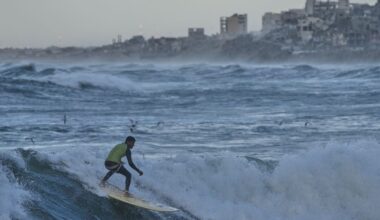 Photos show surfers riding waves along Gaza City’s damaged coastline :: WRAL.com