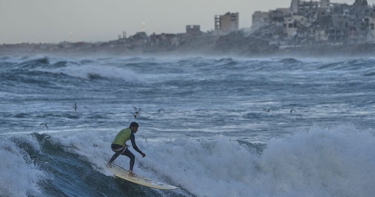 Photos show surfers riding waves along Gaza City’s damaged coastline :: WRAL.com