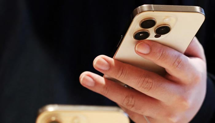 A man checks an iPhone 16 Pro at an Apple store. — Reuters/File