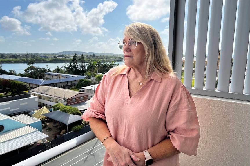 Vicki Blackburn stands on her balcony overlooking Mackay. 